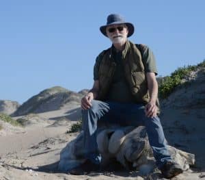 Ken Doud sitting on top of a (real) whale vertebra. Courtesy photo.